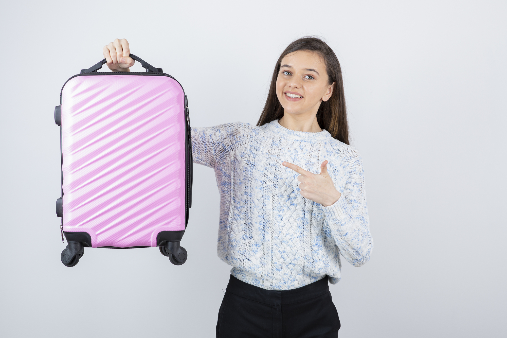 Losing Luggage on Your Family Vacation - Young girl holding a carryon bag