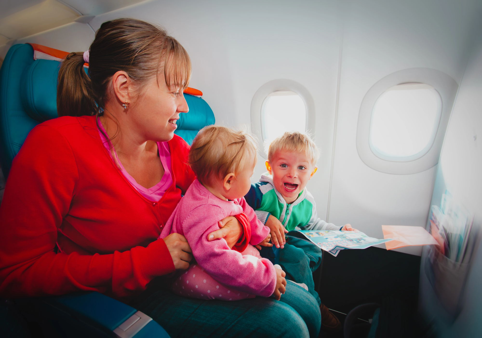 First International Trip? 10 Things You Need to Know Before You Go - Family on an Airplane
