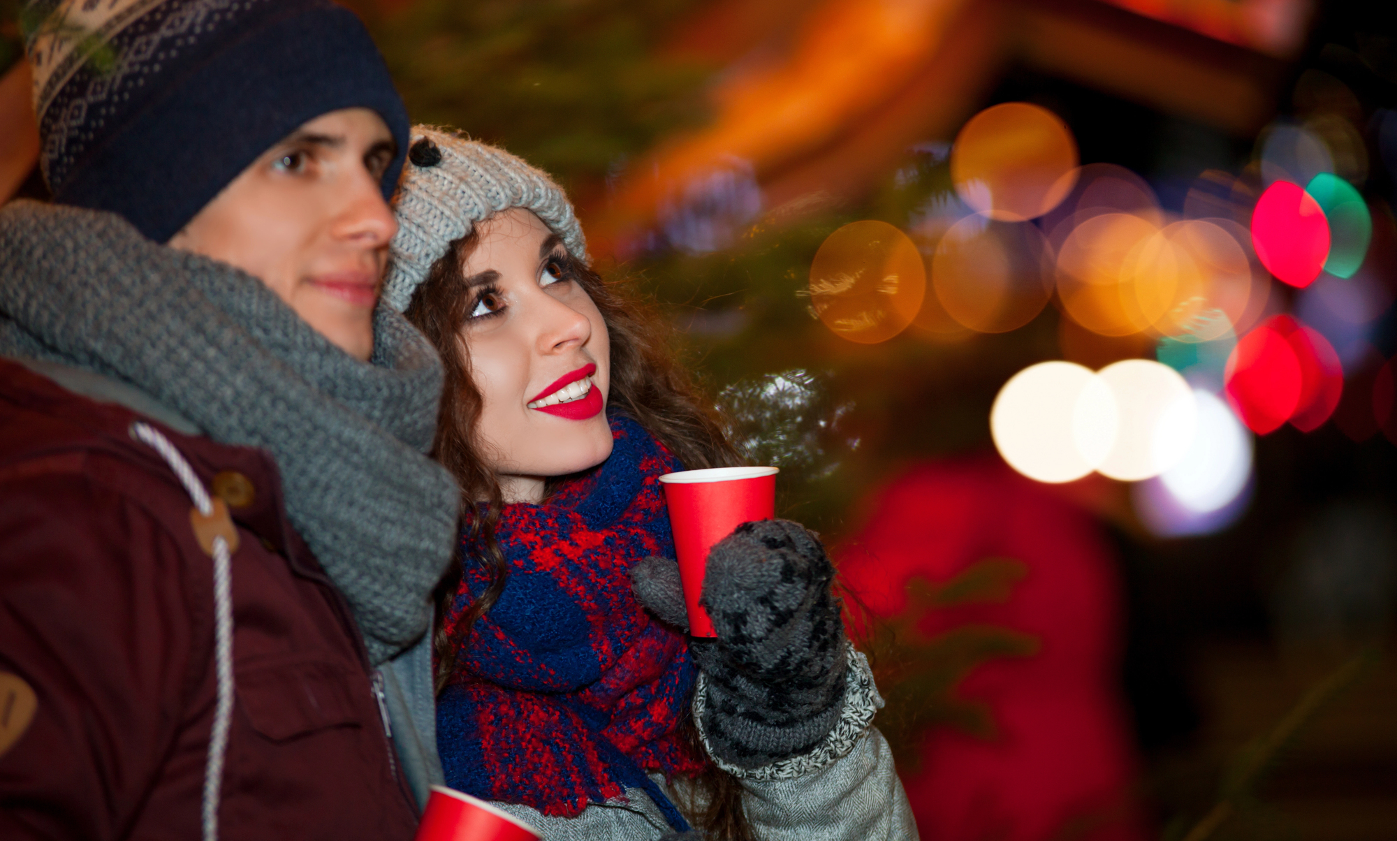 Couple drinking a hot drink at a Christmas market