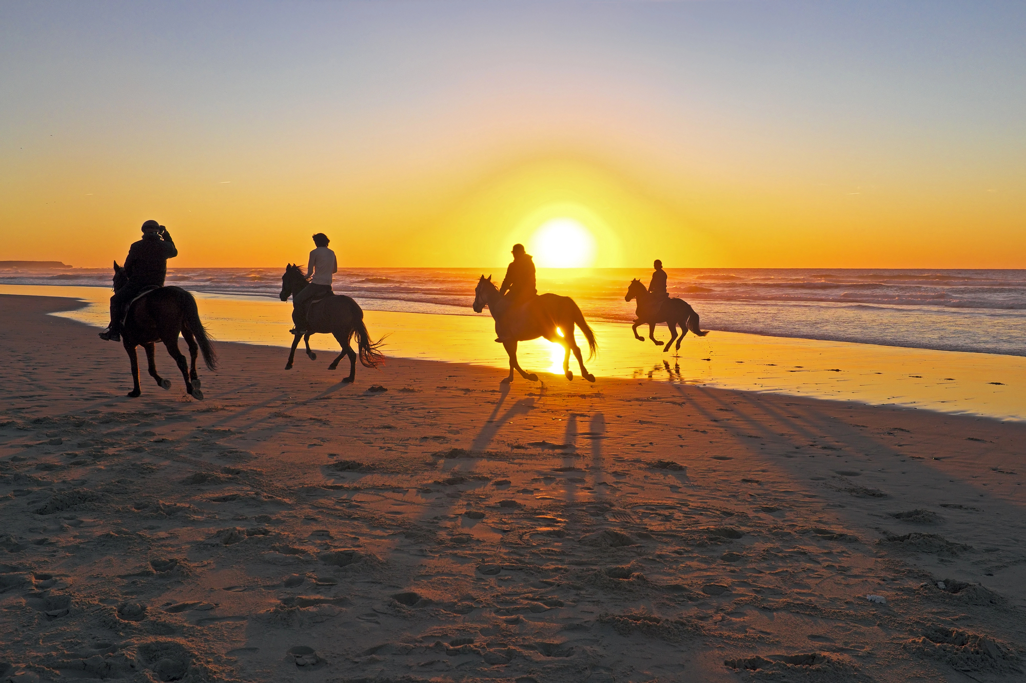 Horseback Riding on the Beach at Sunset