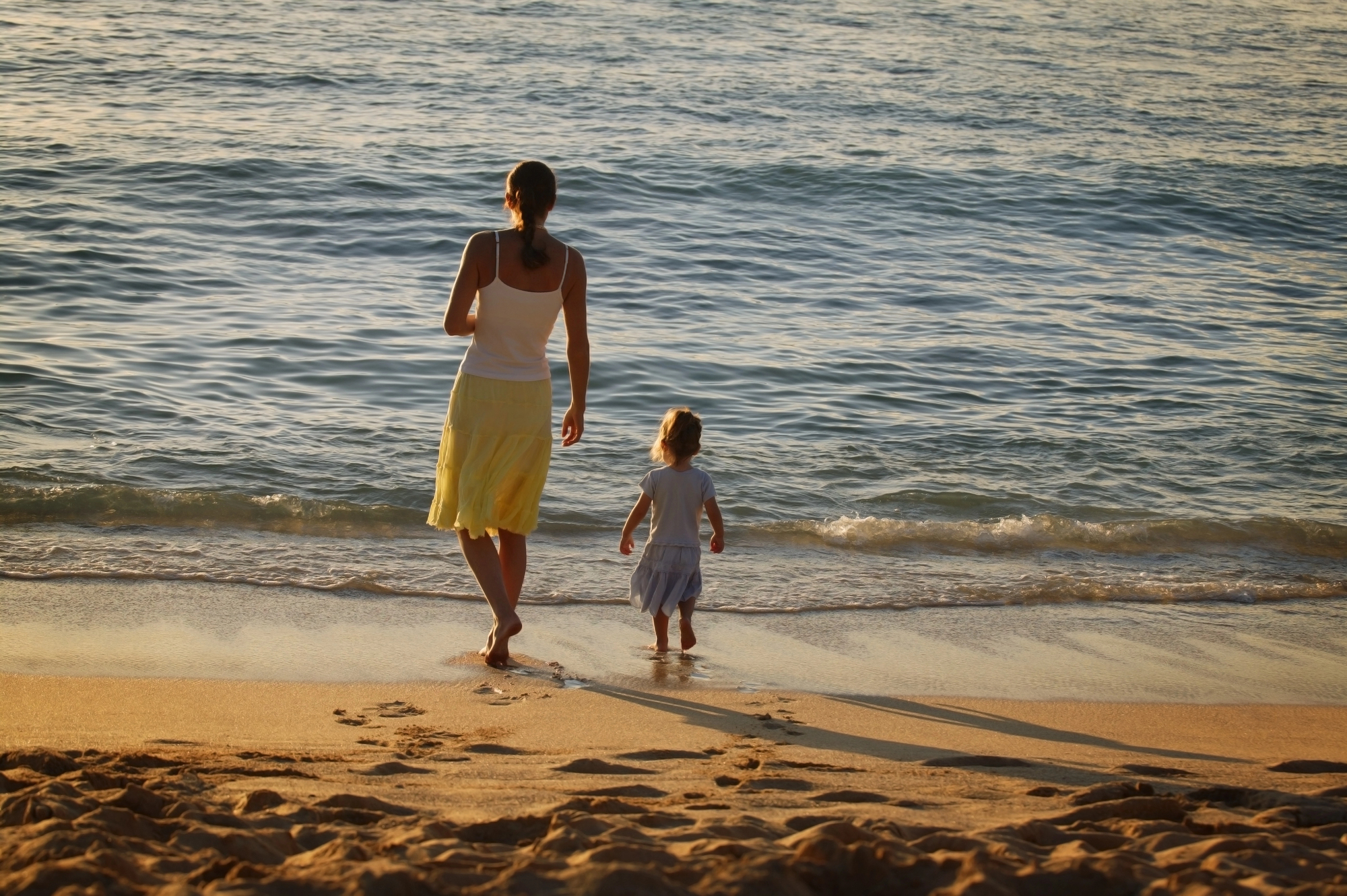 Beach Vacations for Family Friendly Fun in the Sun Activities - Mother and Daughter Walking on the Beach Making Memories 