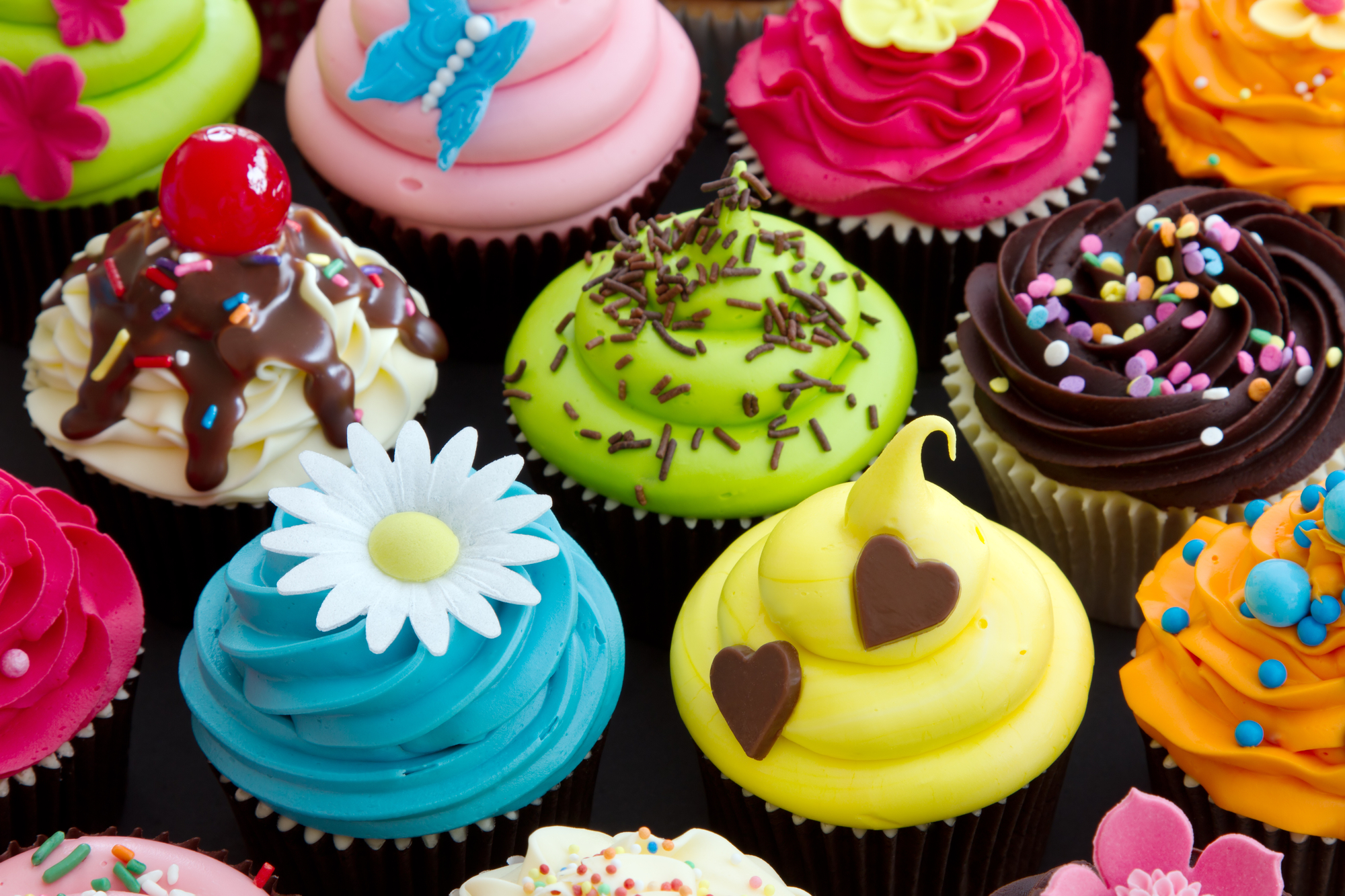 Assortment of brightly decorated cupcakes