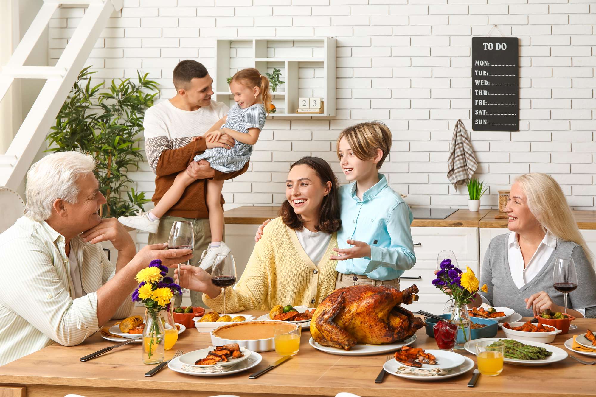 Plan a Family Vacation During Thanksgiving - Family Eating and Talking While Enjoying a Thanksgiving Meal