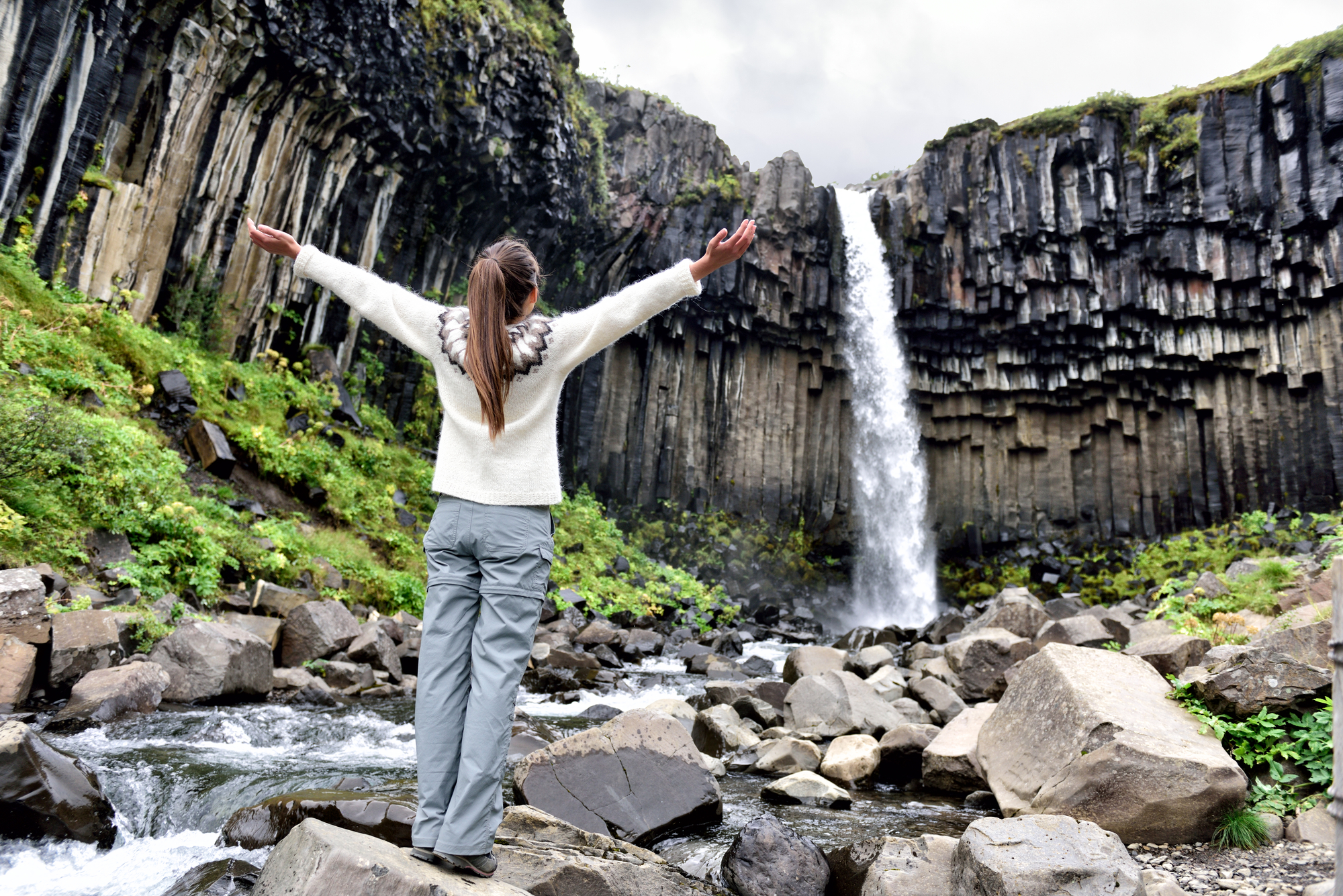 Best Places for Single Women to Travel - Solo Female Traveler at the Svartifoss Waterfall in Iceland