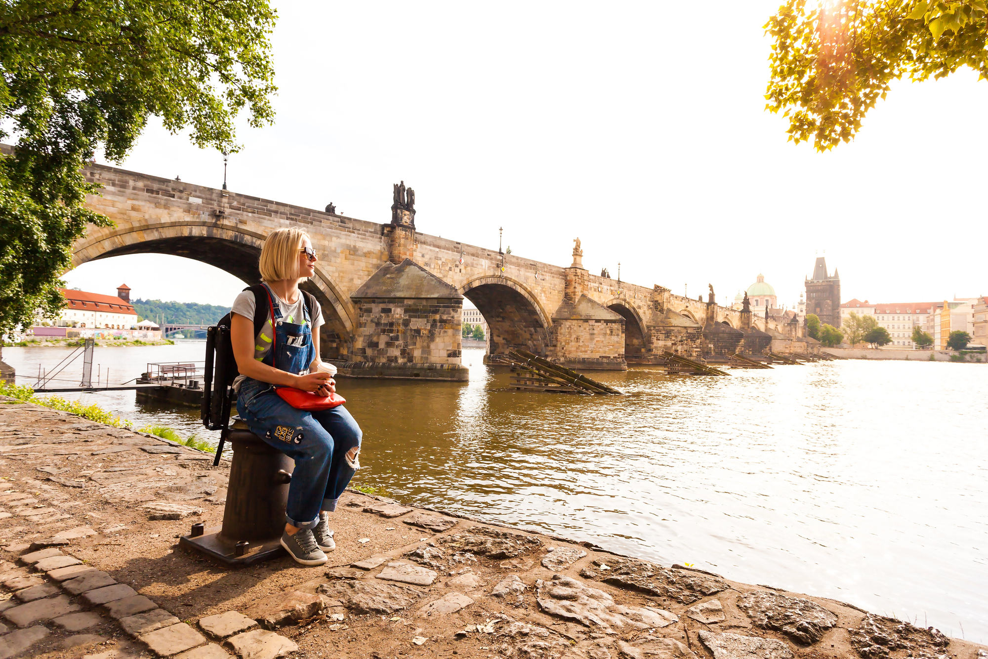 Best Historical Destinations for Solo Women Travelers - Solo Female Traveler Sitting Near the Charles Bridge in Prague