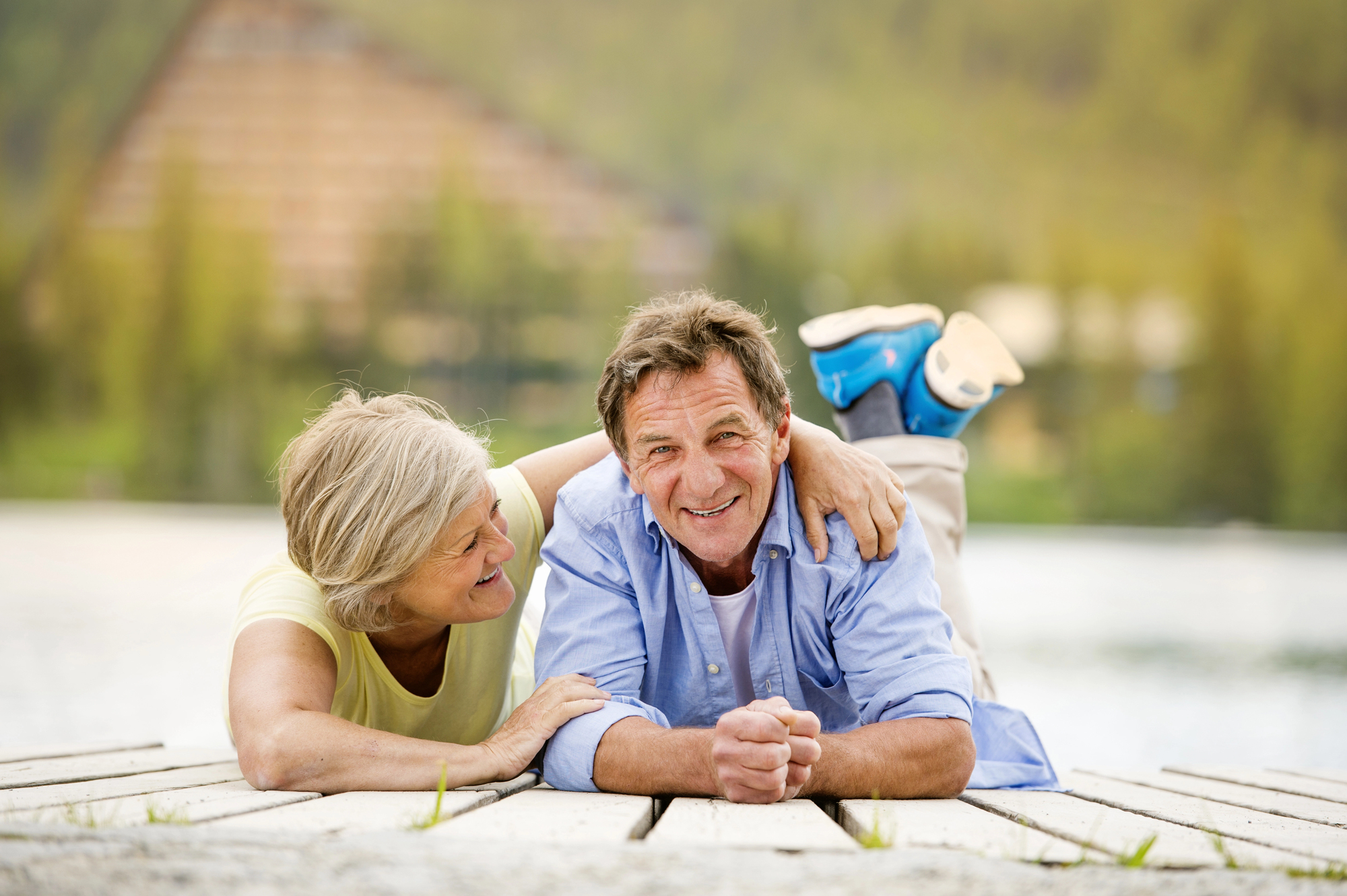 Best Destinations for Empty Nesters: Rediscover the Joy of Adventure Together - Empty Nesters Couple on a Pier Laughing