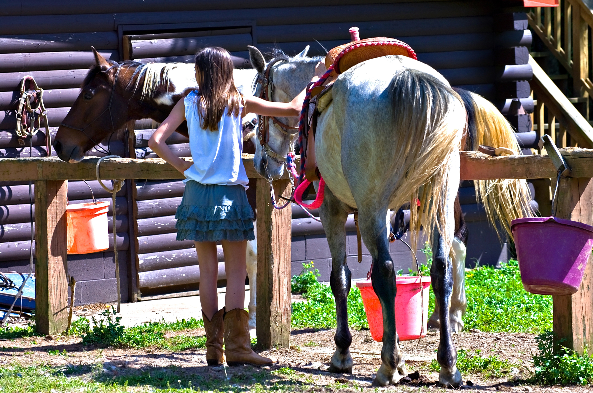 Best Multigenerational Trips in the US - Pre Teen Girl Preparing for Horseback Riding During a Multigenerational Trip