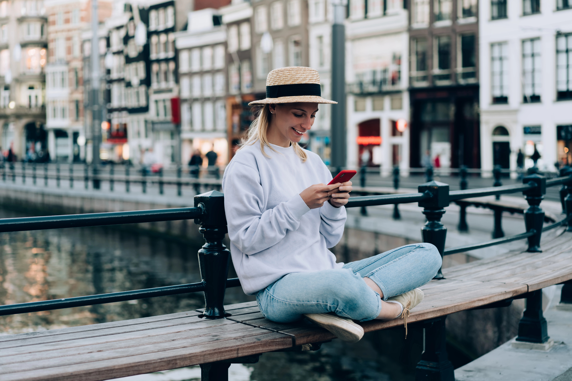Best Countries for Solo Female Travelers: Where to Go for Your First Trip Alone - Young Female Sitting by the Canals in Amsterdam, The Netherlands