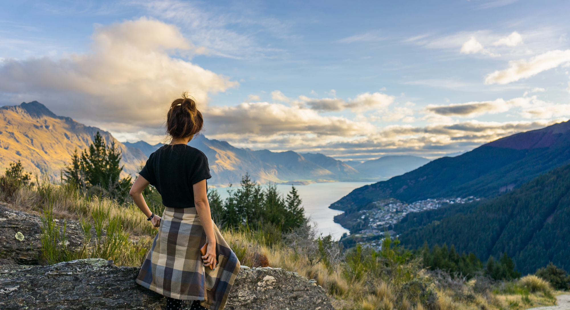 Best Hiking Trails for Solo Female Travelers: Safe, Scenic, and Empowering Adventures - Woman hiking solo near Lake Wakatipu in Switzerland