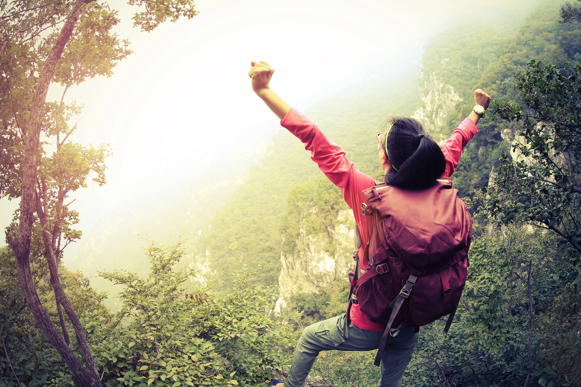 Solo Female Hiker Cheering Her Accomplishments on a Hiking Trail
