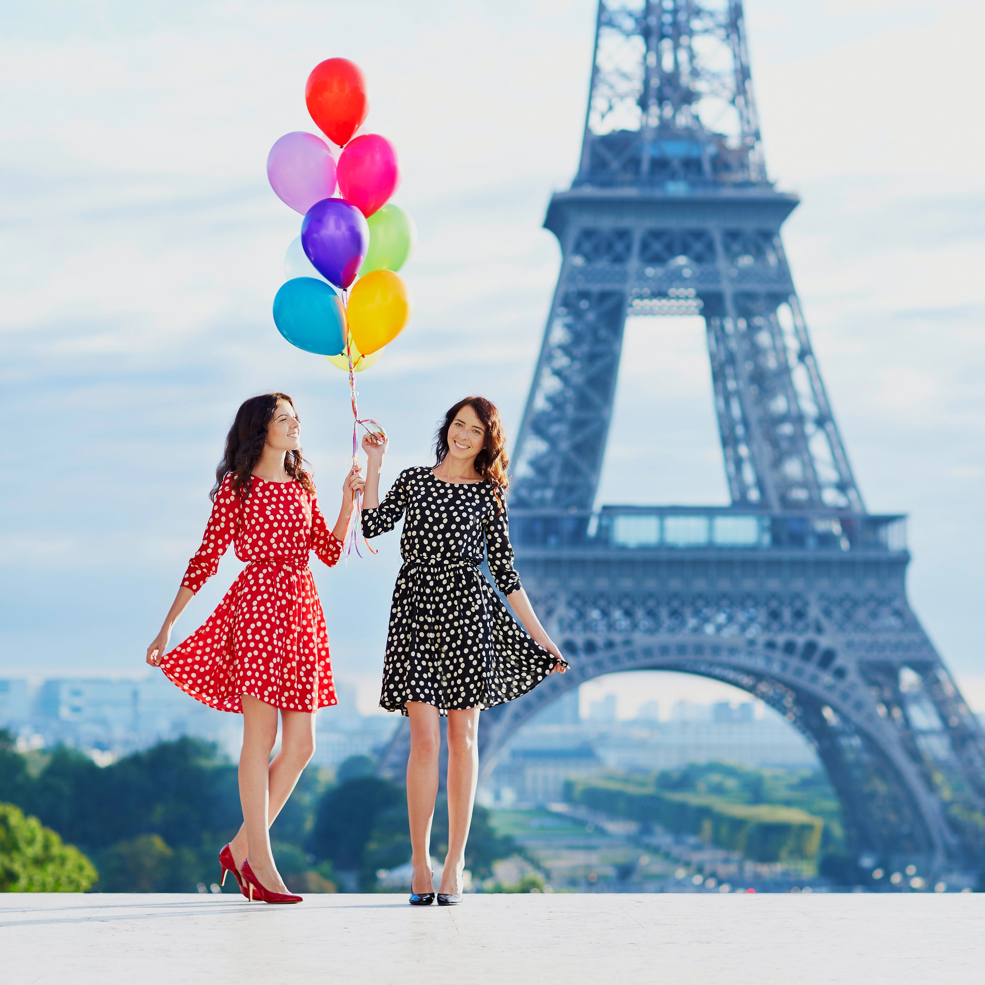 Life is Short and the World is Big: Why Milestone Moments Deserve Milestone Travel - Sisters Celebrating Birthday with Balloons near Eiffel Tower in Paris France